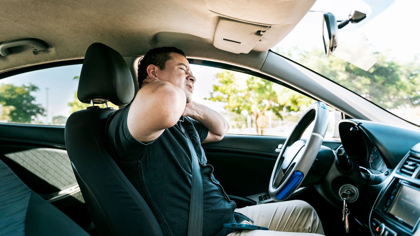 Man Suffering from Neck Pain While Sitting In A Car
